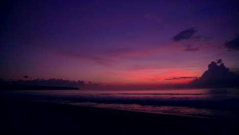 Bright-colorful-sunset-or-sunrise-at-ocean-with-clouds-at-tropical-beach