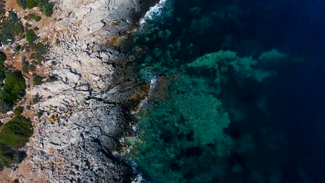 Aerial-footage-of-beautiful-steep-rocky-coast-line,-turquoise-ocean-water,-big-cliffs-coast-line.-4k