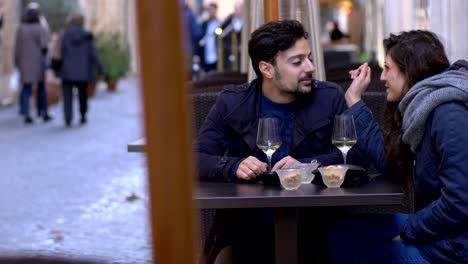 woman-in-love-feeding-her-boyfriend-at-restaurant--outdoor