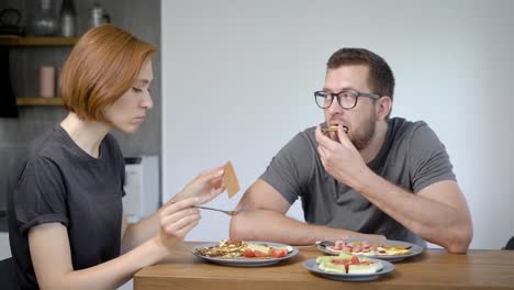 Relaxed-couple-having-delicious-breakfast