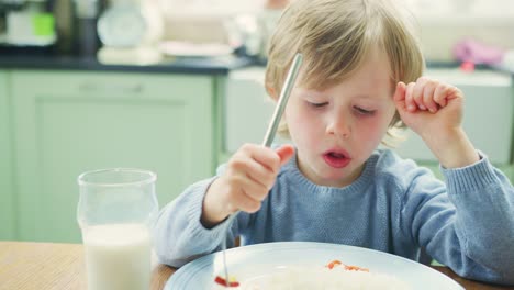 Boy-Dipping-Meat-In-Sauce-While-Having-Meal