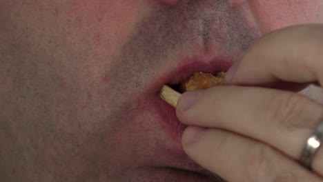 Young-man-eating-hamburger,-close-up