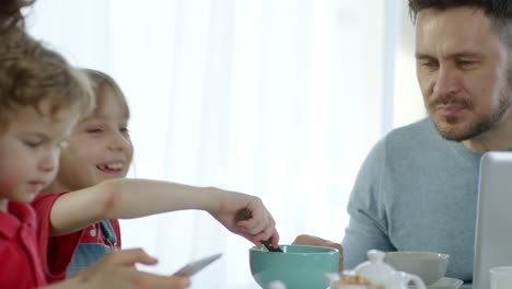 Little-Girl-Feeding-Father-and-Laughing