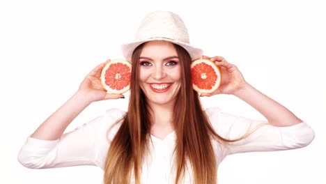 Woman-holds-two-halfs-of-grapefruit-citrus-fruit-in-hands-4K