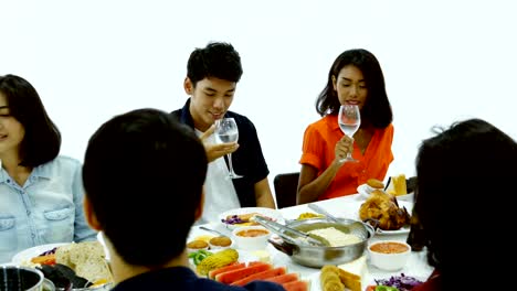 Group-of-asian-people-having-dinner-at-new-year-party-together.-People-Sitting-Around-a-Table-and-eating-food-together.-People-with-new-year-party-concept.