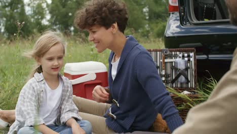 Happy-Family-Enjoying-Picnic-on-Windy-Day