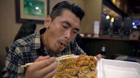 slow-motion-tattooed-asian-man-eating-and-devouring-chinese-takeout-food