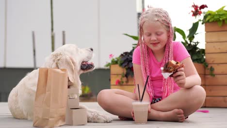 love-for-pets---beautiful-fashion-girl-with-african-pigtails-eats-on-the-street-with-her-dog