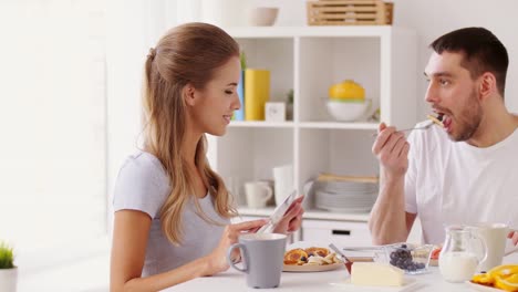 happy-couple-having-breakfast-at-home