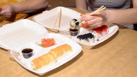 Japanese-food.-A-woman-eats-rolls,-delivered-to-the-house