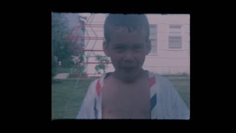 1964-Portrait-of--Little-boy-eats-and-plays-for-camera