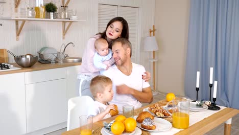 happy-mother,-father-and-son-having-breakfast-at-home