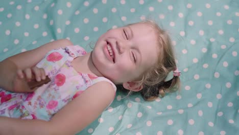 Happy-Child-Lying-And-Laughing-From-Tickling-Closeup