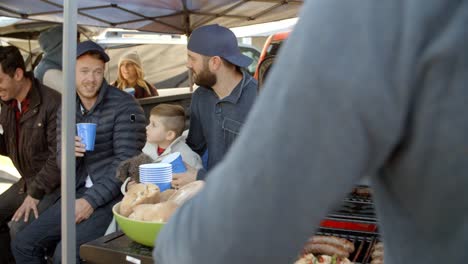 Slow-Motion-Shot-Of-Sports-Fans-Tailgating-In-Parking-Lot