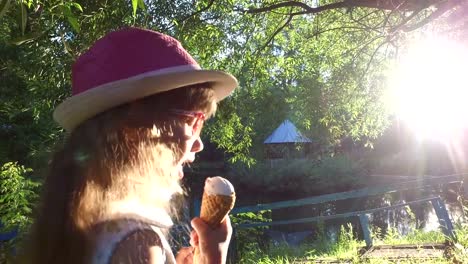 Little-girl-with-long-hair-eats-ice-cream-in-the-park.