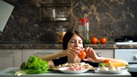 beautiful-smiling-woman-cook-play-with-vegetables-on-table-in-kitchen-at-home