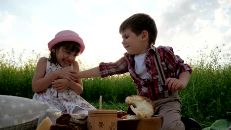 Children-having-fun-in-fresh-air,-kid-at-picnic,-family-resting-in-nature,-friends-laugh-happily,-good-mood,-healthy-food-for-healthy-child