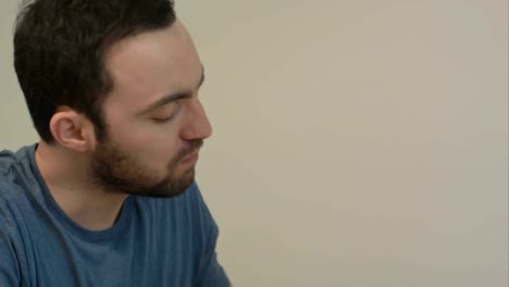 Young-man-enjoying-croisssant-for-breakfast-in-the-morning