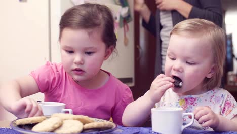 Two-sisters-having-breakfast-at-the-table.