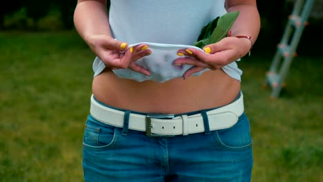 Woman-holds-a-cherries-inside-T-shirt