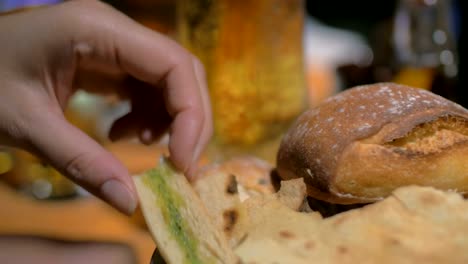 Beer-glass-and-eating-bruschetta-with-topping