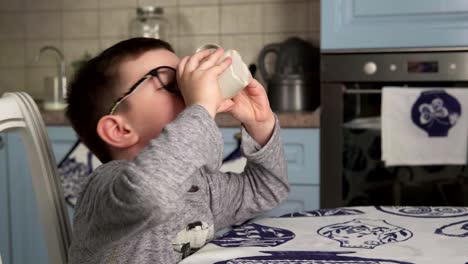 Little-boy-is-drinking-milk-and-showing-thumbs-up
