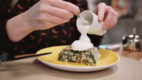 Una-niña-irreconocible-vierte-una-salsa-de-strudel-de-postre-en-un-restaurante-y-comer-con-un-tenedor-y-cuchillo