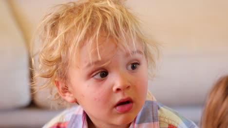 Infant-toddler-baby-boy-acting-surprised-by-what-he-is-watching-on-TV-screen.-Baby-male-seeing-fixated-to-what-is-on-screen-with-a-surpsied-expression-on-his-face-in-4k-resolution