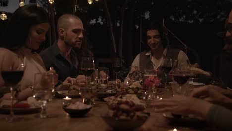 Young-multi-ethnic-friends-and-couples-celebrating-at-elegant-dinner-party