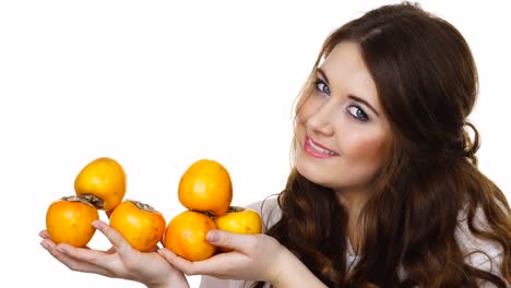 Cheerful-woman-holds-persimmon-kaki-fruits,-isolated