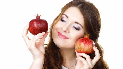 Cheerful-woman-holds-pomegranate-fruits