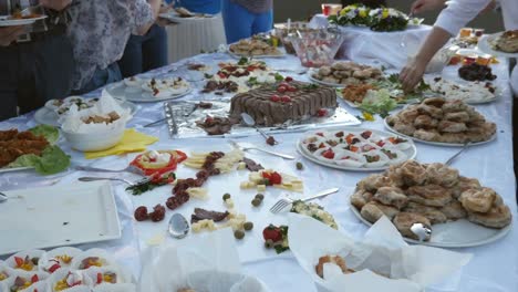 Footage-of-several-people-taking-food-on-their-plates-from-a-Swedish-table