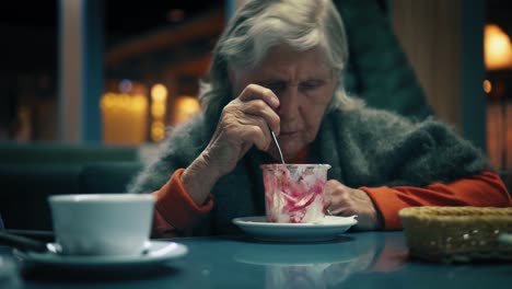 Beautiful-aged-female-is-eating-dessert-at-a-cafe