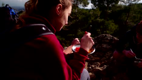 Young-friends-having-a-picnic-on-the-mountain