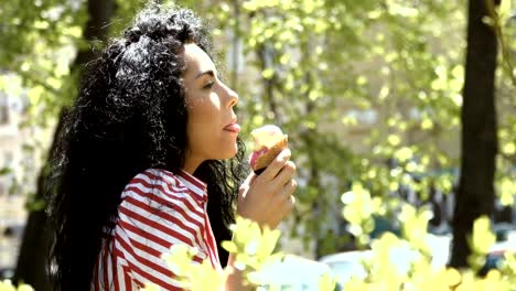 Brunette-eat-ice-cream-in-park