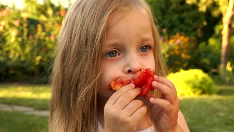 The-girl-is-eating-a-tomato