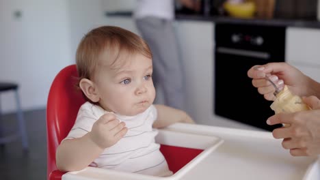 Mother-giving-meal-to-baby-boy