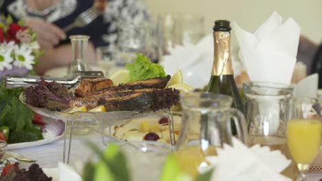 People-celebrate-holidays-at-festive-dinner.-Close-up-of-dining-table