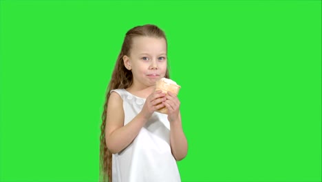 Kid-girl-eating-with-ice-cream-on-a-Green-Screen,-Chroma-Key