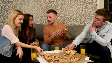 Young-people-in-casual-clothes-eating-pizza,-talking,-laughing