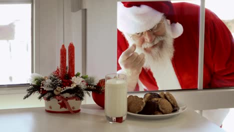 Santa-Claus-quiere-probar-leche-y-galletas-y-mirar-a-través-de-un-vidrio