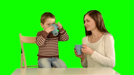 Son-with-his-mother-drinking-tea-on-a-Green-Screen