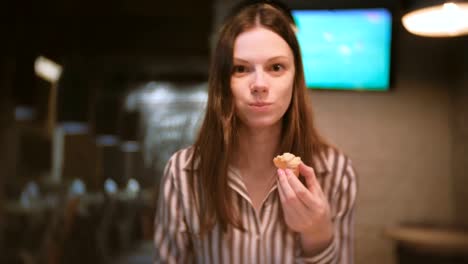 Young-beautiful-woman-brunette-eats-sandwich-with-pate.