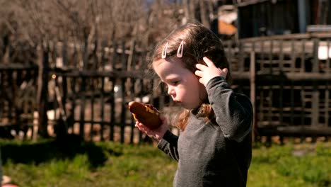 Young-cute-little-girl-eats-a-sandwich-with-cutlet-and-cheese.