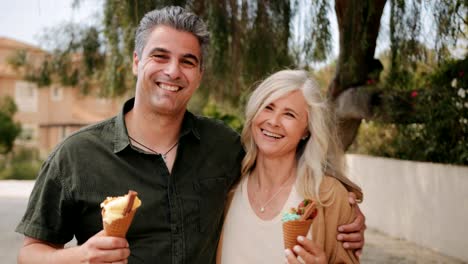 Happy-multi-ethnic-mature-couple-eating-ice-cream-in-spring