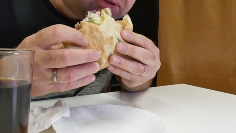 The-man-eats-kebabs-with-his-hands