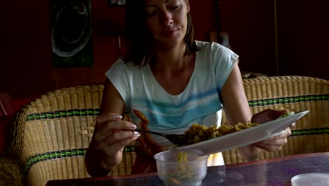 Woman-moves-food-from-dish-to-container