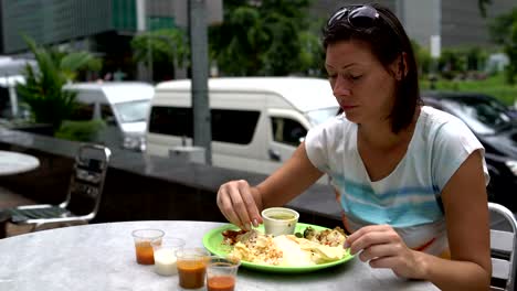 A-woman-breaks-a-traditional-Indian-cake-and-eats-thali-with-her-hands