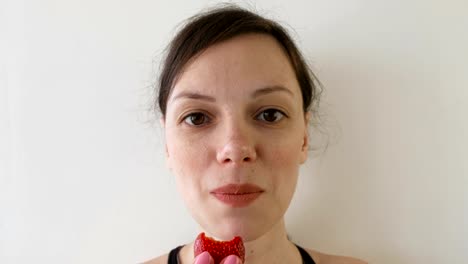 Portrait-of-woman-eating-strawberries.-Front-view.