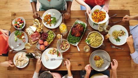 Grupo-de-personas-que-comen-en-la-mesa-con-la-comida